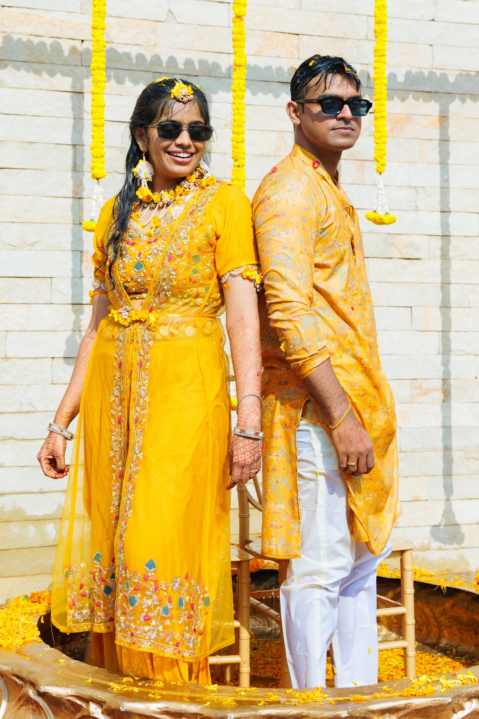 Couple wearing yellow for their haldi celebration
