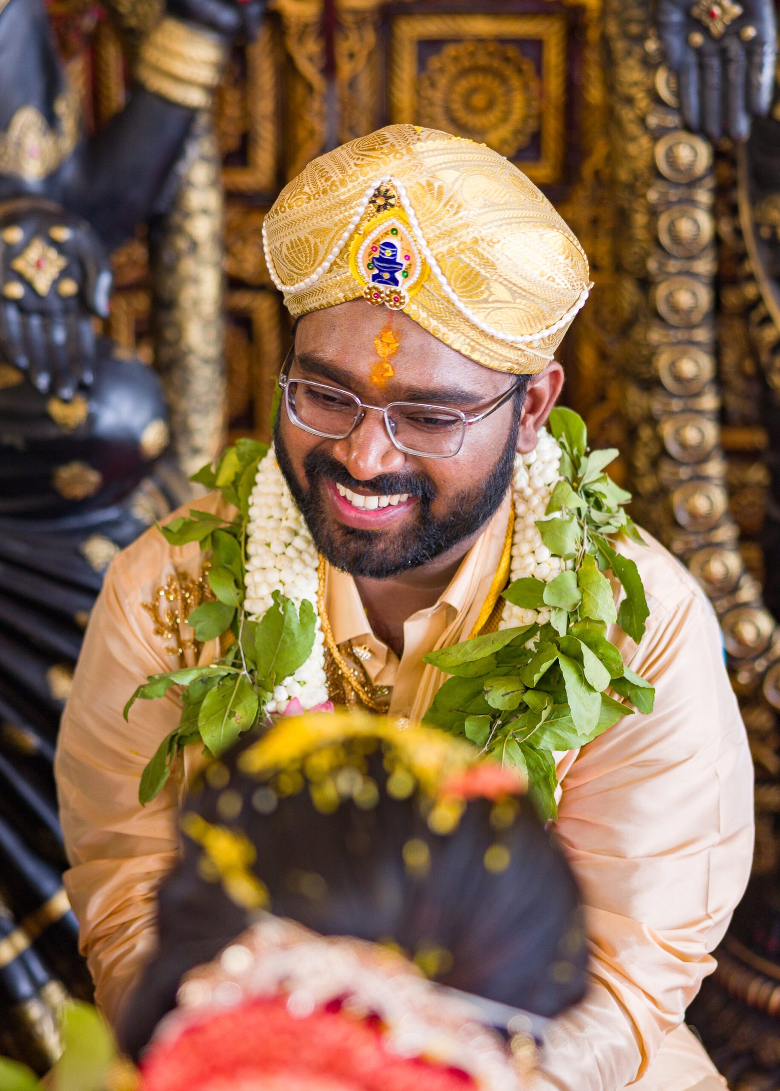 Groom smiling during a traditional wedding ceremony