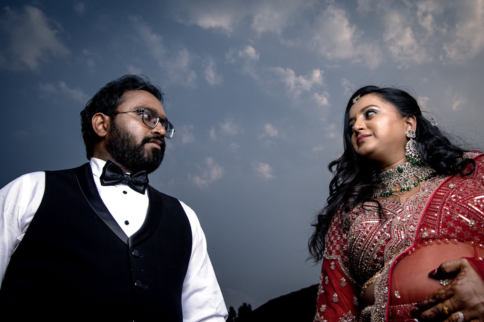 Couple portrait beneath a dramatic evening sky